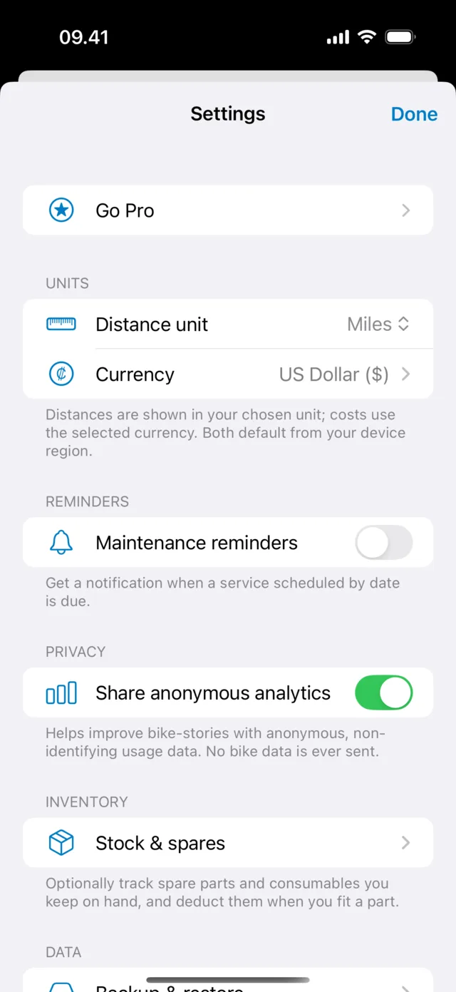 The Settings screen showing distance unit and currency, maintenance reminders, and a Share anonymous analytics toggle with a note that no bike data is ever sent